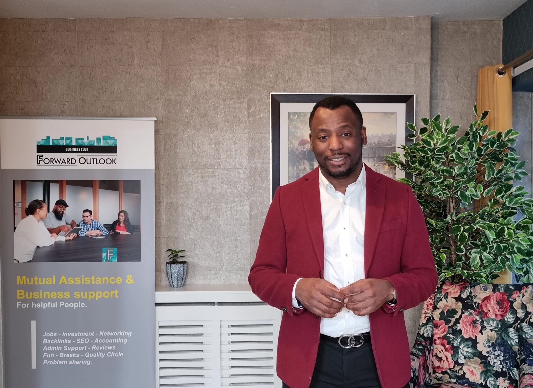 Gabriel Topman presenting beside a business support display